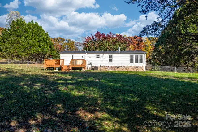a front view of a house with a garden and trees