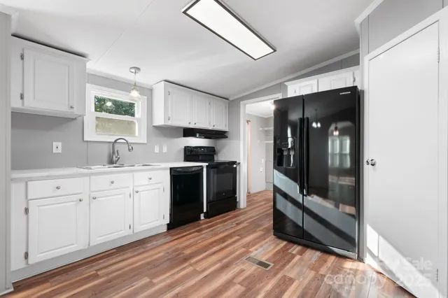 a kitchen with granite countertop a refrigerator and a stove
