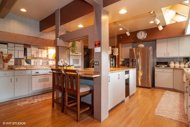 1N765 Brundige Road Elburn, IL 60119 - Photo 14 of 49 a kitchen with stainless steel appliances kitchen island granite countertop a table chairs sink and cabinets