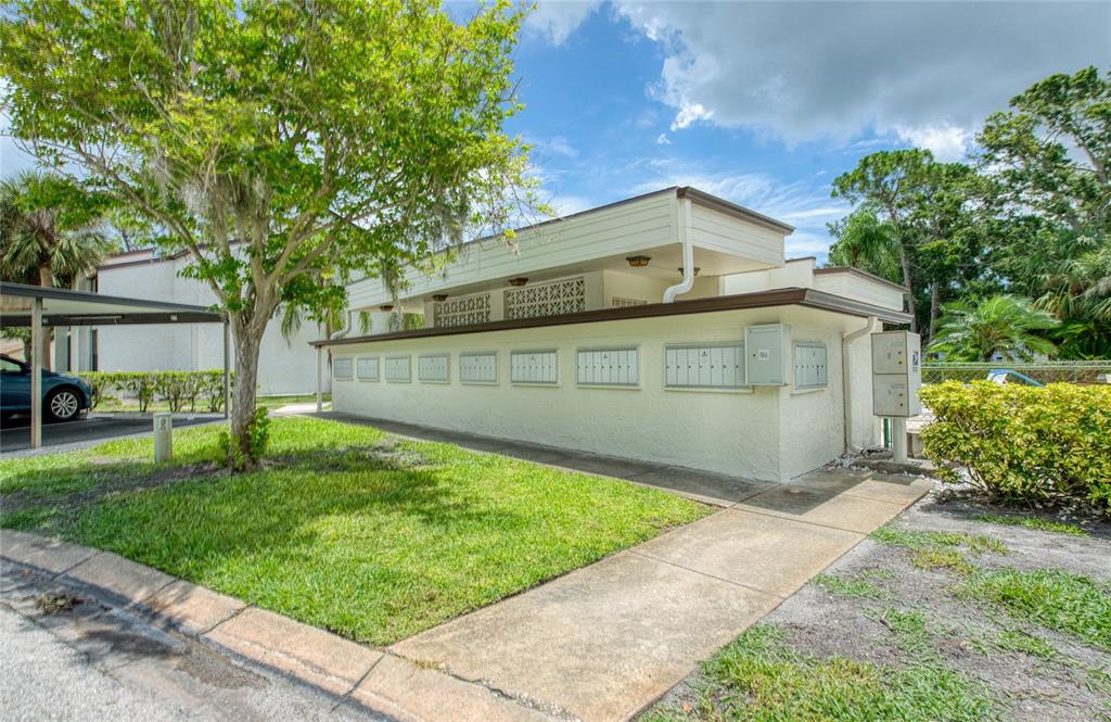 700 Starkey Road, Unit 1145 Largo, FL 33771 - Photo 42 of 63 a front view of a house with a yard and trees