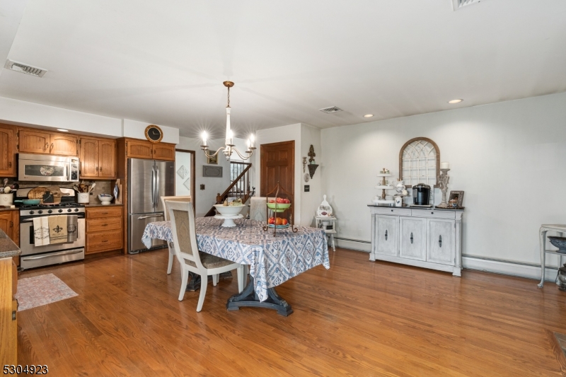 64 Mattison Road Branchville, NJ 07826 - Photo 12 of 40 a living room with furniture a dining table wooden floor and a fireplace