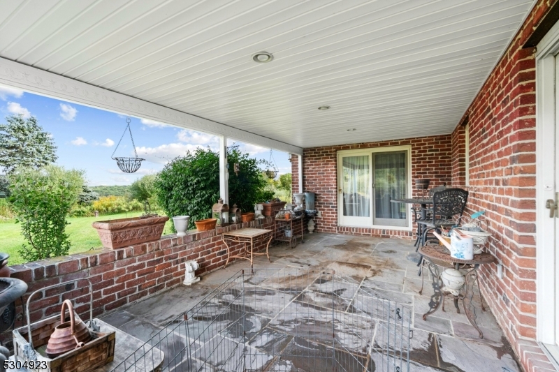 64 Mattison Road Branchville, NJ 07826 - Photo 23 of 40 a view of a patio with table and chairs and potted plants