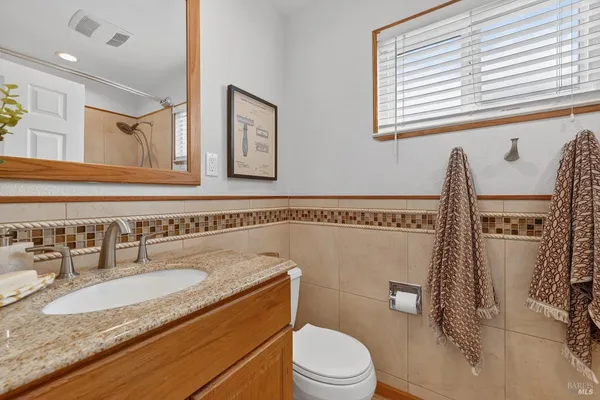 a bath tub sitting next to a white sink and a shower
