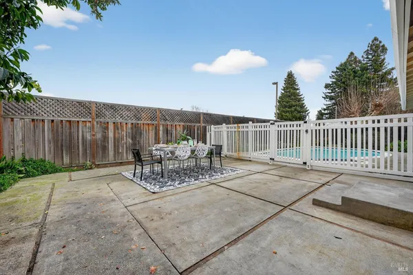 a view of a patio with a table and chairs
