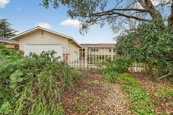 a view of a house with a yard and garage