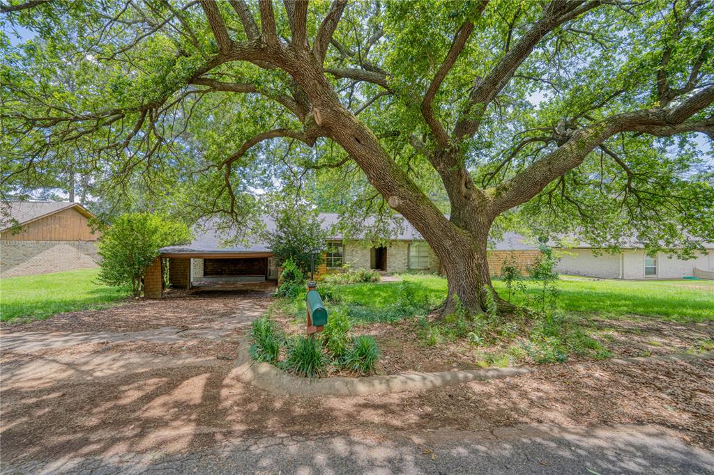 1006 Rikkity Lane Mount Pleasant, TX 75455 - Photo 2 of 39 a front view of a house with garden