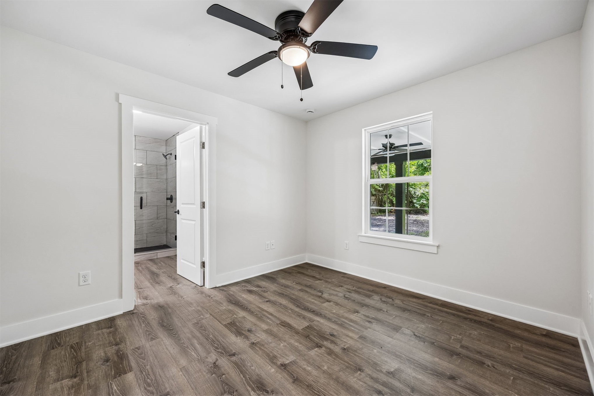 552 Sunset Road Fernandina Beach, FL 32034 - Photo 9 of 23 wooden floor in an empty room with a window