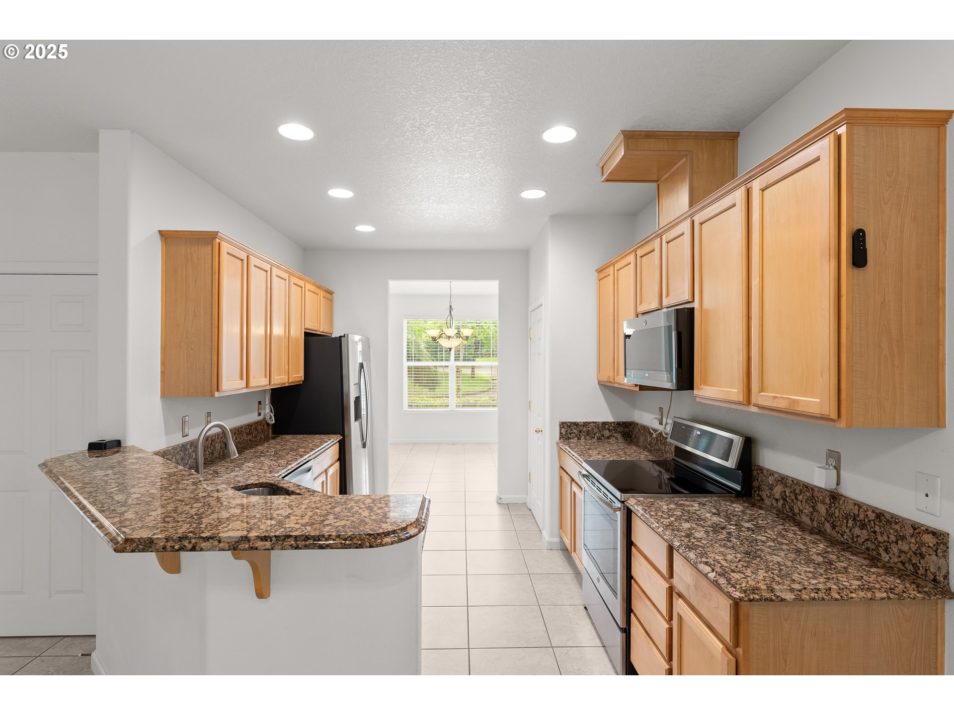 1971 Southwest 19th Terrace Gresham, OR 97080 - Photo 2 of 31 a kitchen with granite countertop kitchen island stainless steel appliances a sink stove and cabinets