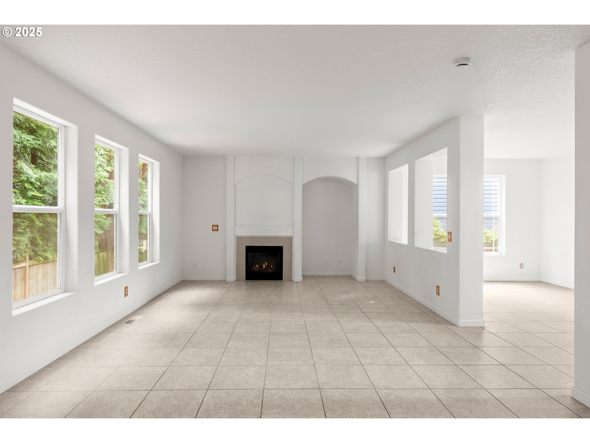 1971 Southwest 19th Terrace Gresham, OR 97080 - Photo 6 of 31 a view of an empty room with a fireplace and a window