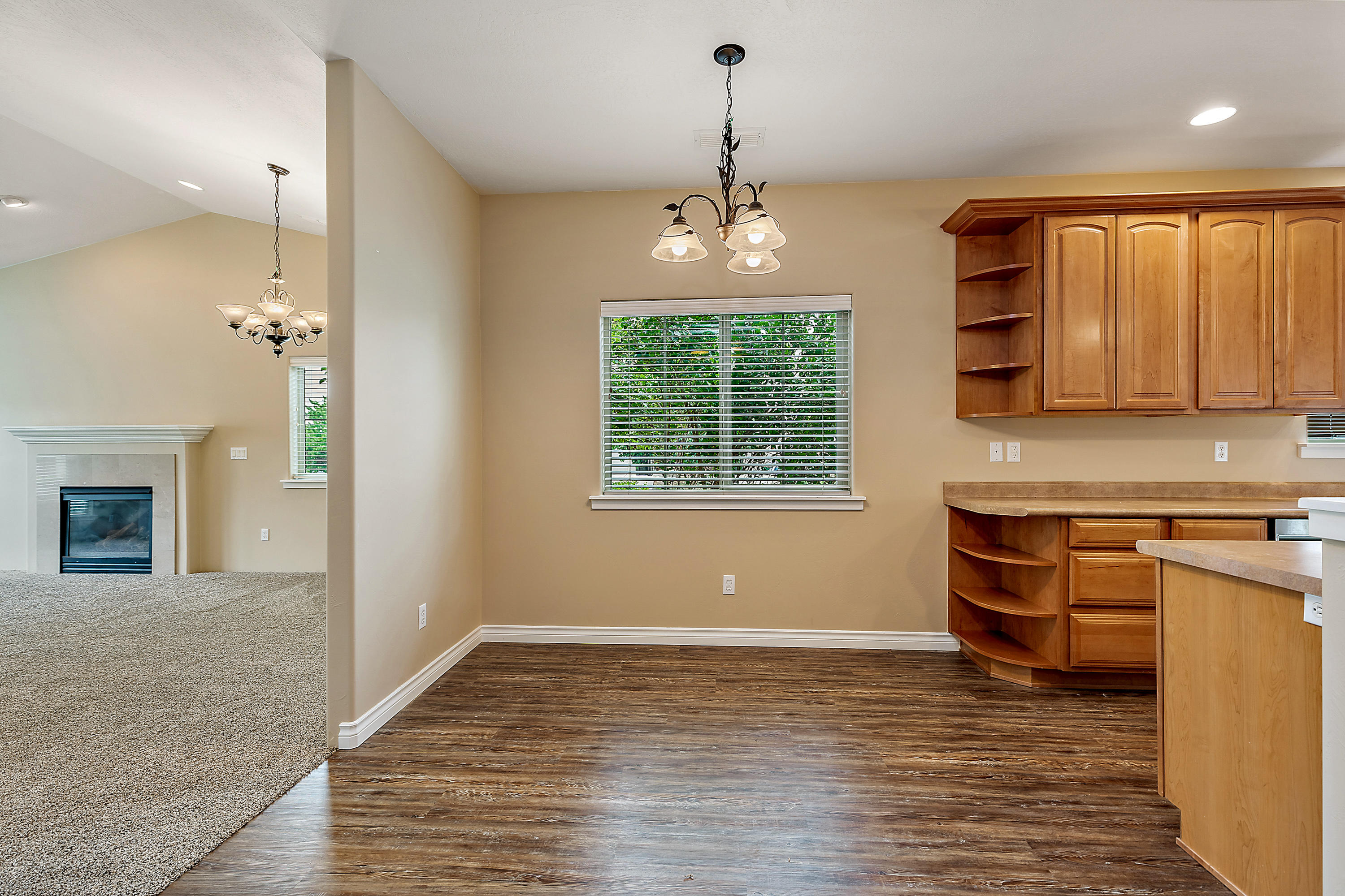 948 Win Way Eagle Point, OR 97524 - Photo 9 of 32 a kitchen with stainless steel appliances granite countertop a stove and a wooden floors