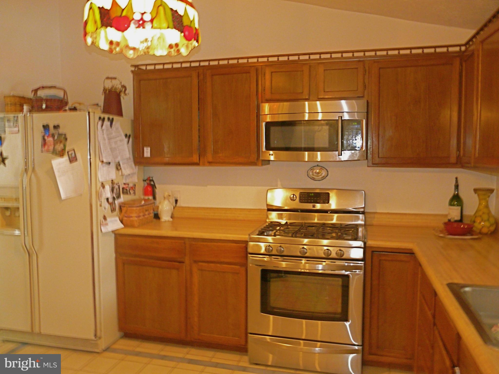 64 Yew Road Baltimore, MD 21221 - Photo 17 of 30 a kitchen with a stove and a microwave