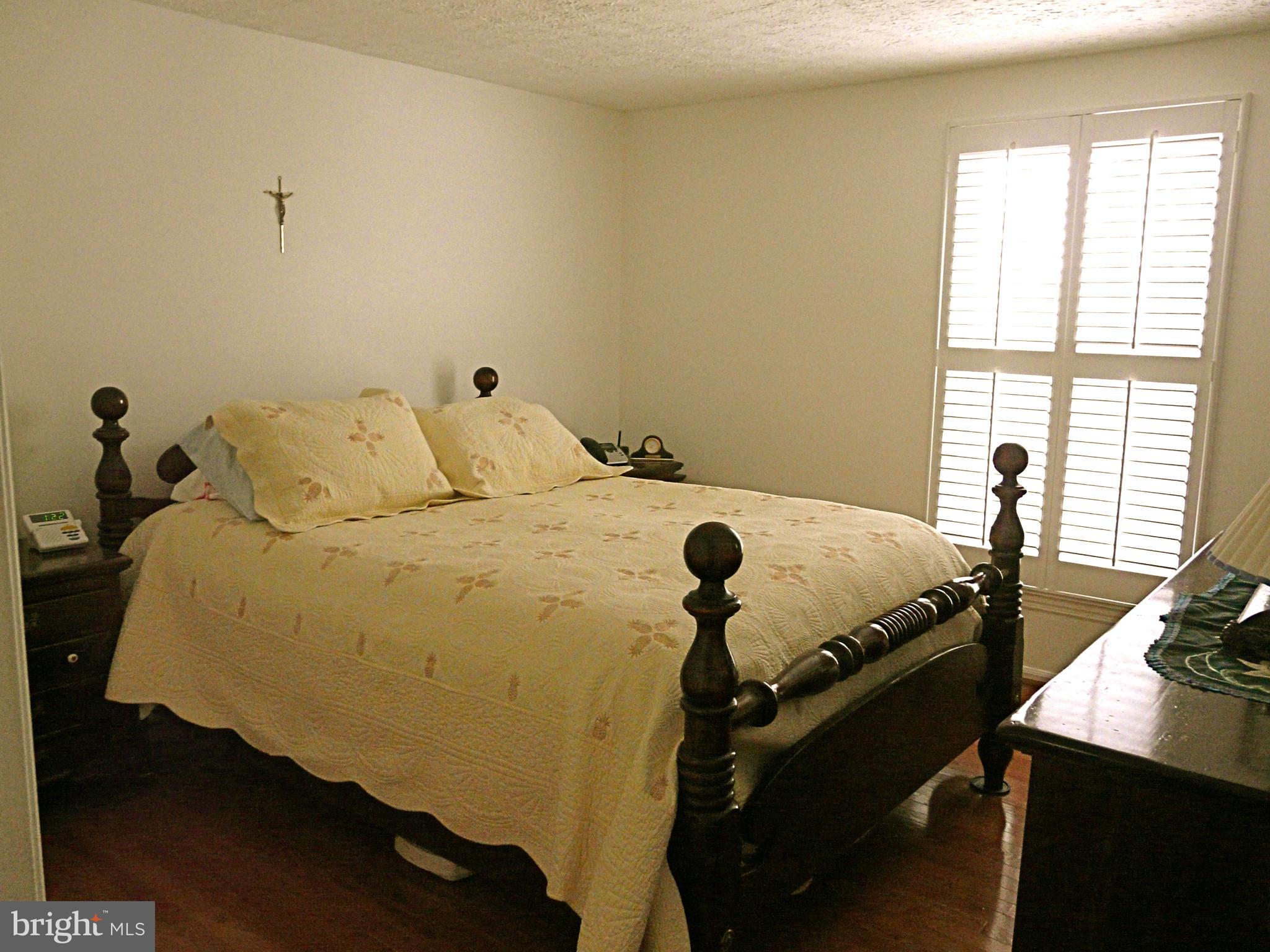 64 Yew Road Baltimore, MD 21221 - Photo 23 of 30 a bed sitting in a bedroom next to a window