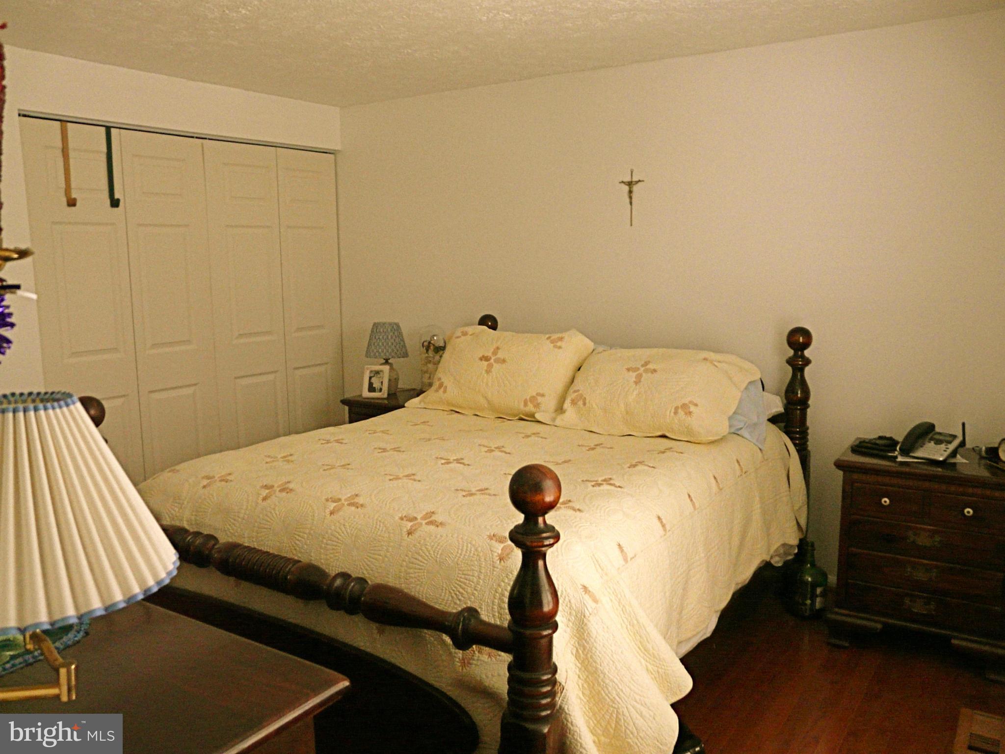 64 Yew Road Baltimore, MD 21221 - Photo 24 of 30 a bedroom with a bed and wooden floor