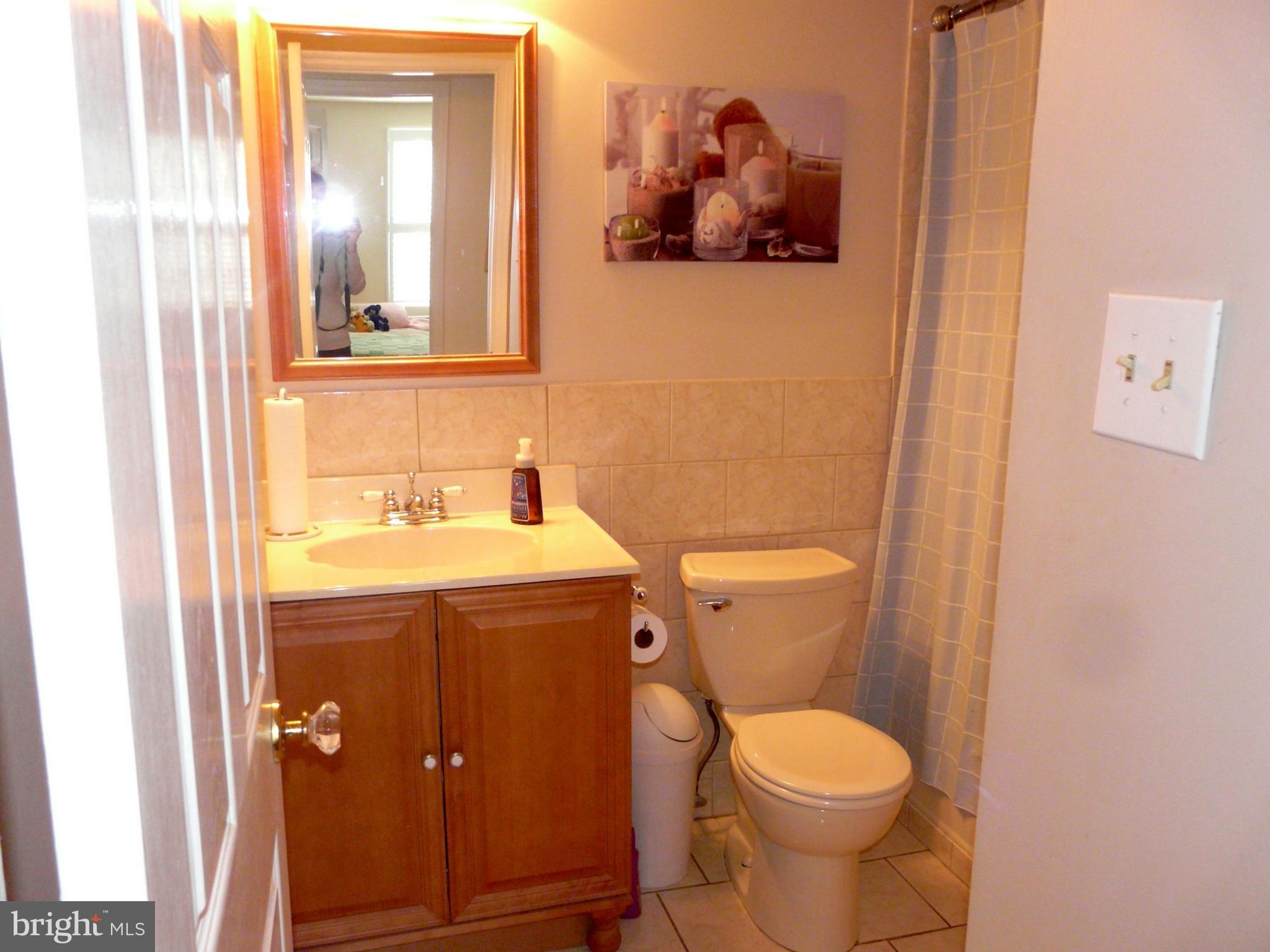 64 Yew Road Baltimore, MD 21221 - Photo 26 of 30 a bathroom with a toilet and a sink