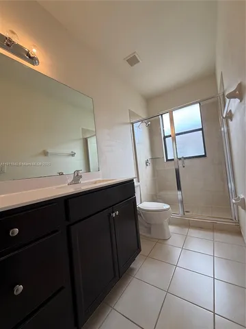 a bathroom with a double vanity sink toilet and mirror