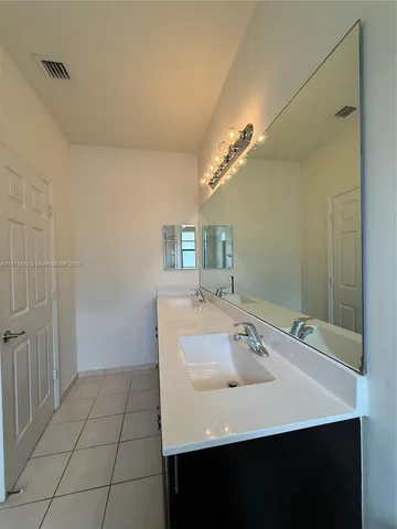 a bathroom with a sink a vanity and a mirror