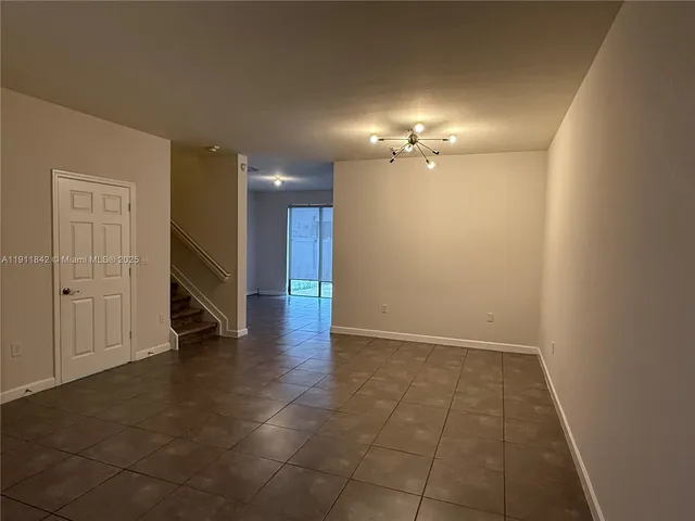 a view of an empty room with a bathroom