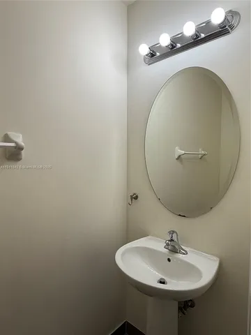 a bathroom with a sink and mirror