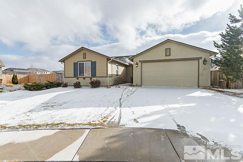 9100 Raytheon Court Reno, NV 89506 - Photo 1 of 1 a front view of a house with a yard and garage