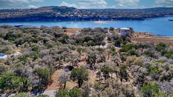 an aerial view of a houses with a lake view