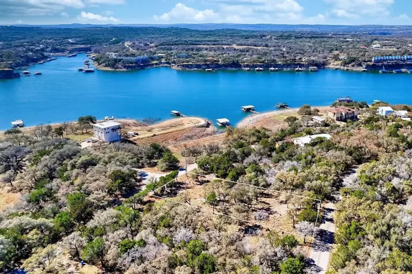 an aerial view of a houses with a lake view and mountain view