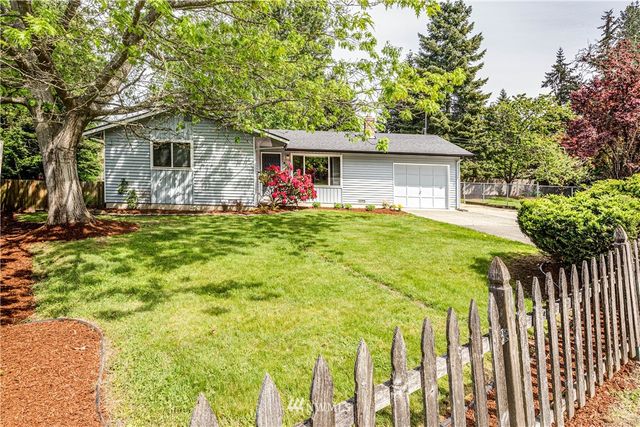 a front view of house with yard and trees