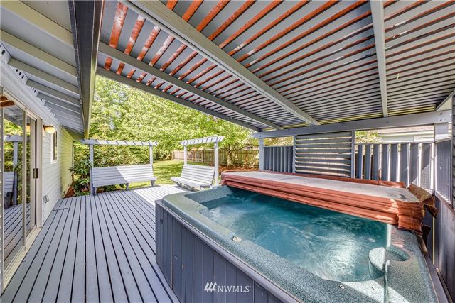 a view of a patio with dining table and chairs with wooden floor