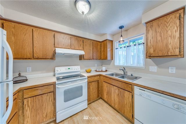 a kitchen with a sink stove and cabinets