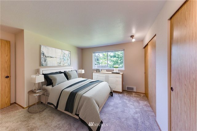 a bed room with a bed and a window