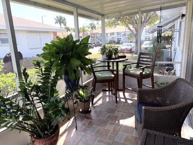 1206 South Lakes End Drive, Unit D Fort Pierce, FL 34982 - Photo 11 of 21 a dining room with furniture and a potted plant