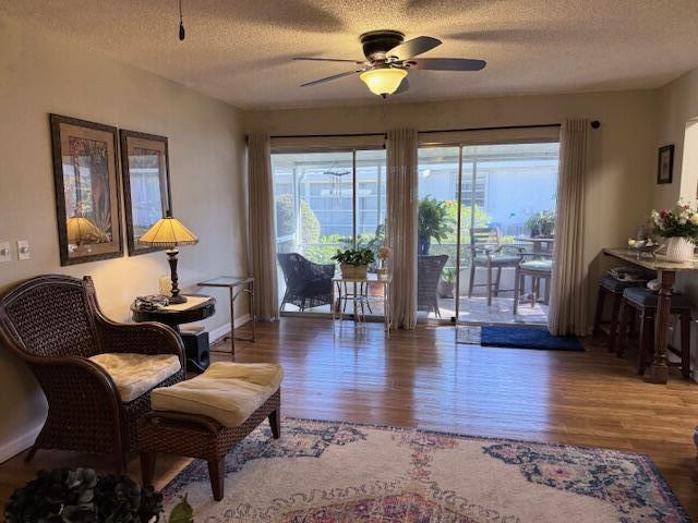 1206 South Lakes End Drive, Unit D Fort Pierce, FL 34982 - Photo 10 of 21 a living room with furniture a flat screen tv and wooden floor