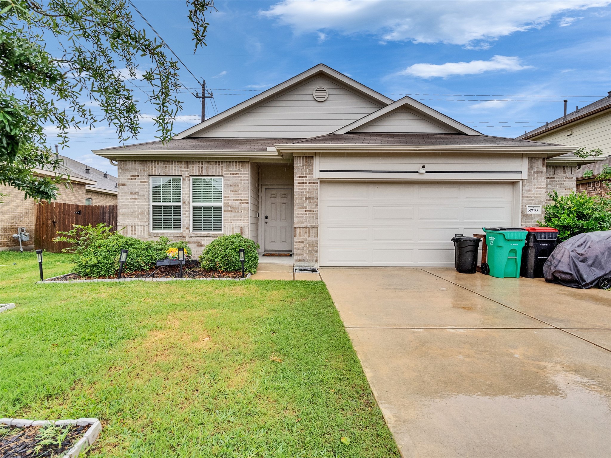 8719 Willet Street Baytown, TX 77521 - Photo 1 of 42 a front view of a house with a yard and potted plants