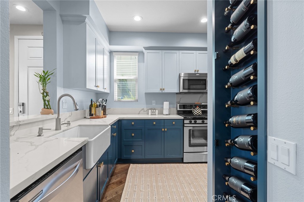 a kitchen with stainless steel appliances granite countertop a sink stove and cabinets