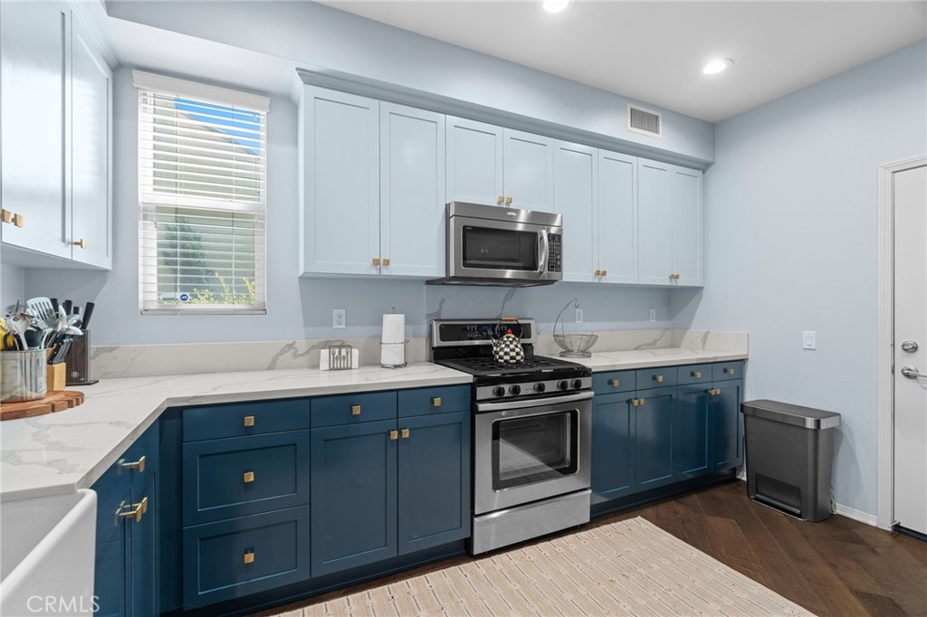 5321 Ocean, Unit 101 Hawthorne, CA 90250 - Photo 9 of 36 a kitchen with stainless steel appliances granite countertop a sink a stove a microwave and wooden cabinets