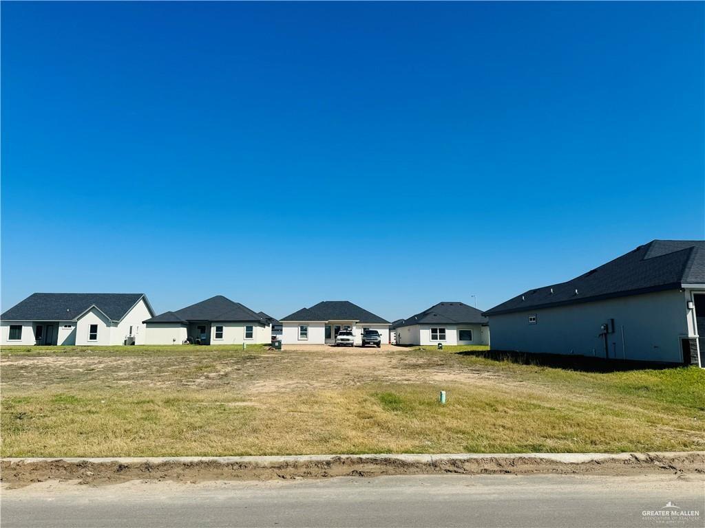 a view of swimming pool with lawn chairs and potted plants