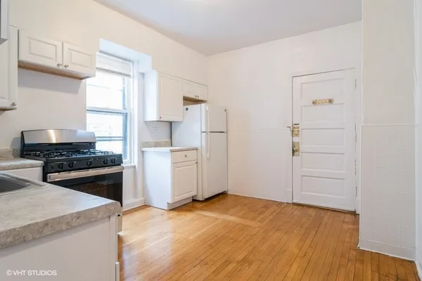 a kitchen with a stove a refrigerator and a sink