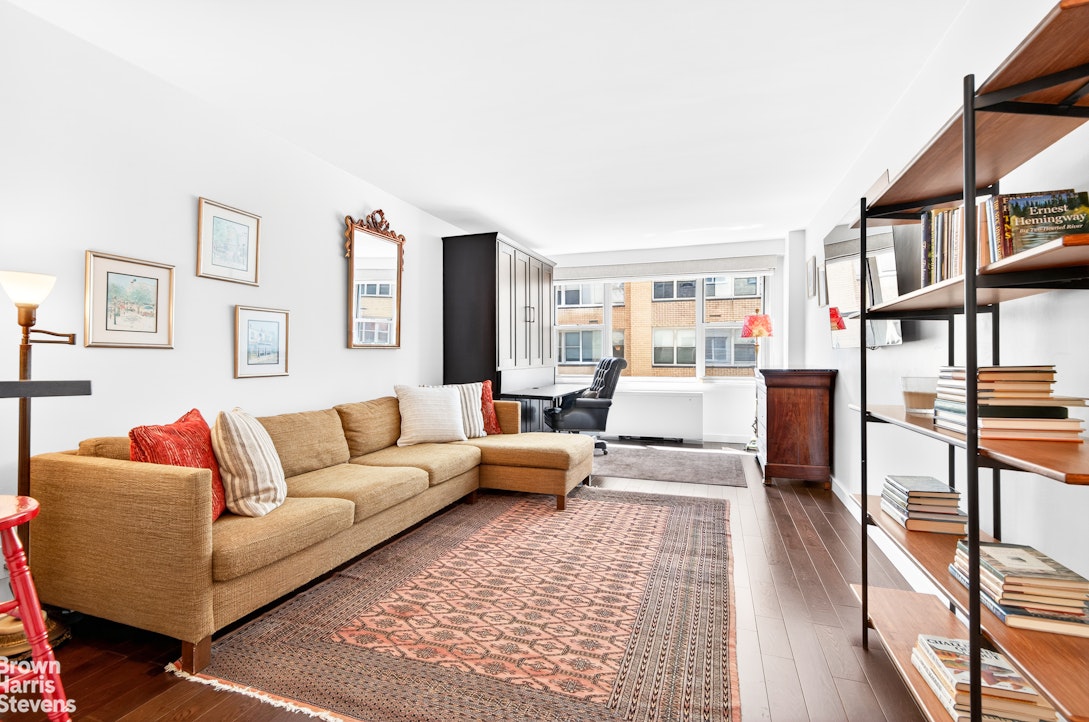 520 East 72nd Street, Unit 3G Manhattan, NY 10021 - Photo 1 of 15 a living room with furniture and a book shelf