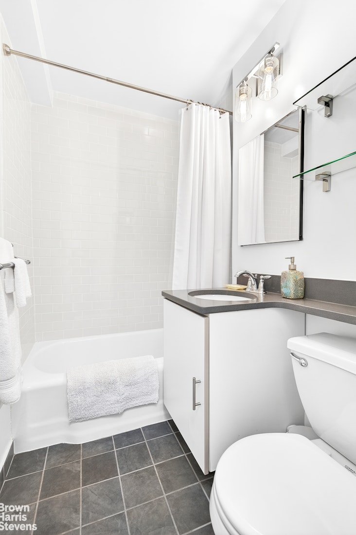 520 East 72nd Street, Unit 3G Manhattan, NY 10021 - Photo 7 of 15 a bathroom with a sink a toilet and shower