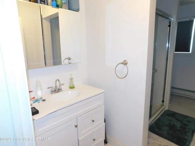 a bathroom with a sink toilet and a mirror