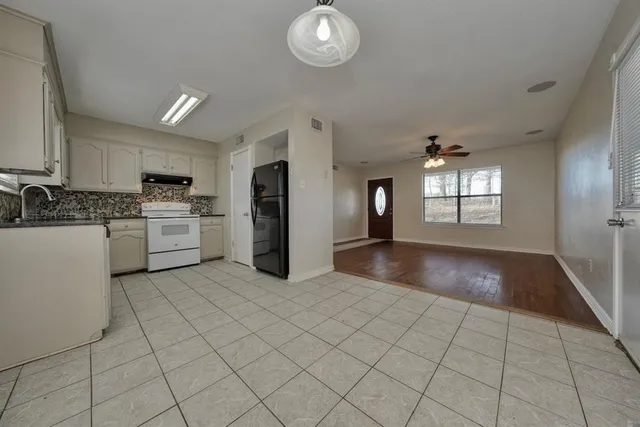 a view of a kitchen with microwave and cabinets