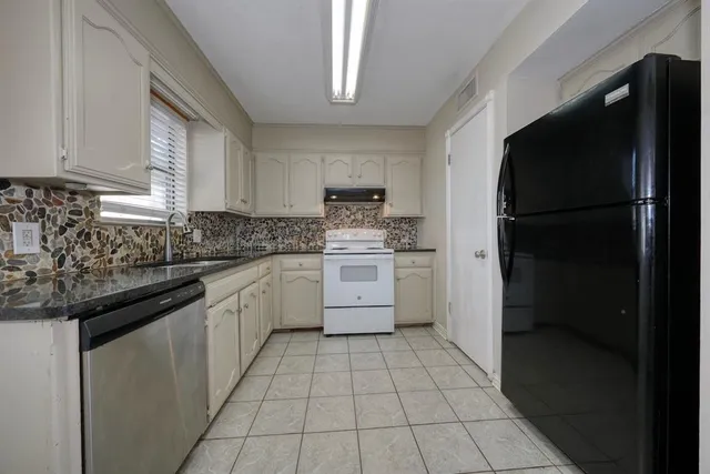 a kitchen with a sink a stove and refrigerator