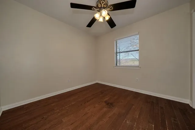 wooden floor in an empty room with a window