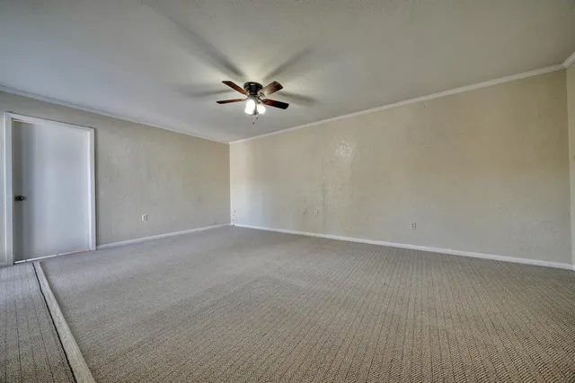 an empty room with a empty space and a ceiling fan