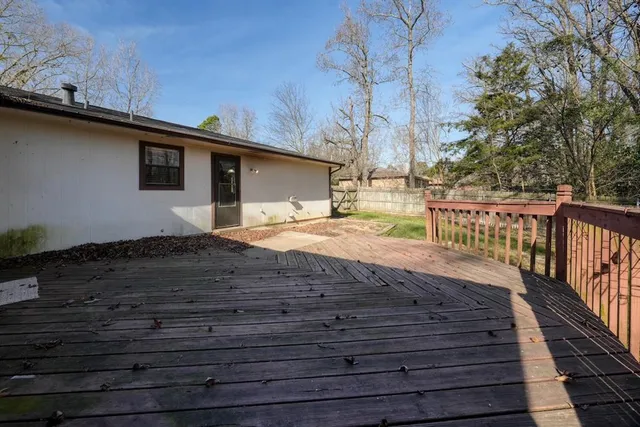 a view of backyard with wooden fence