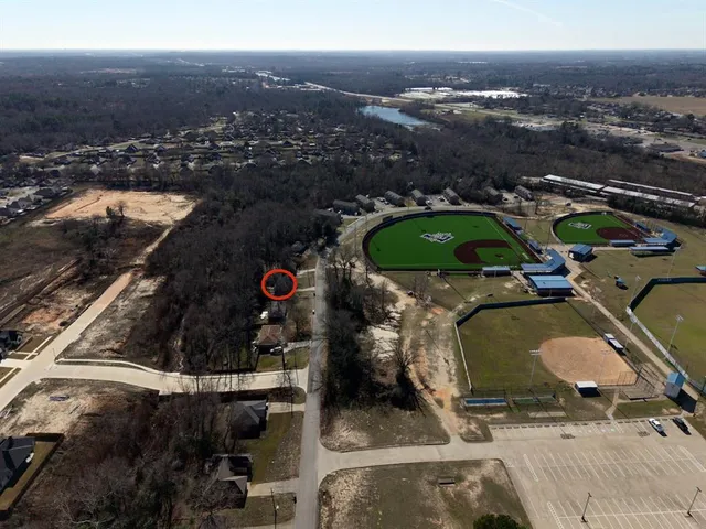 an aerial view of a house with a swimming pool yard and mountain view in back