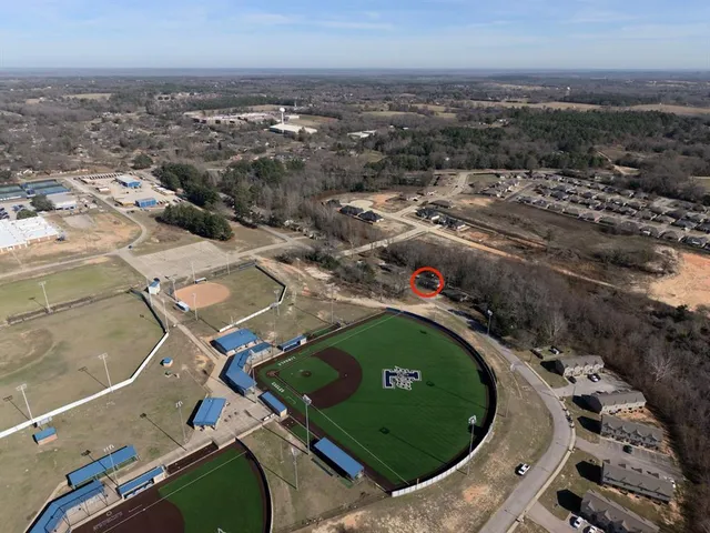 an aerial view of a residential houses with outdoor space