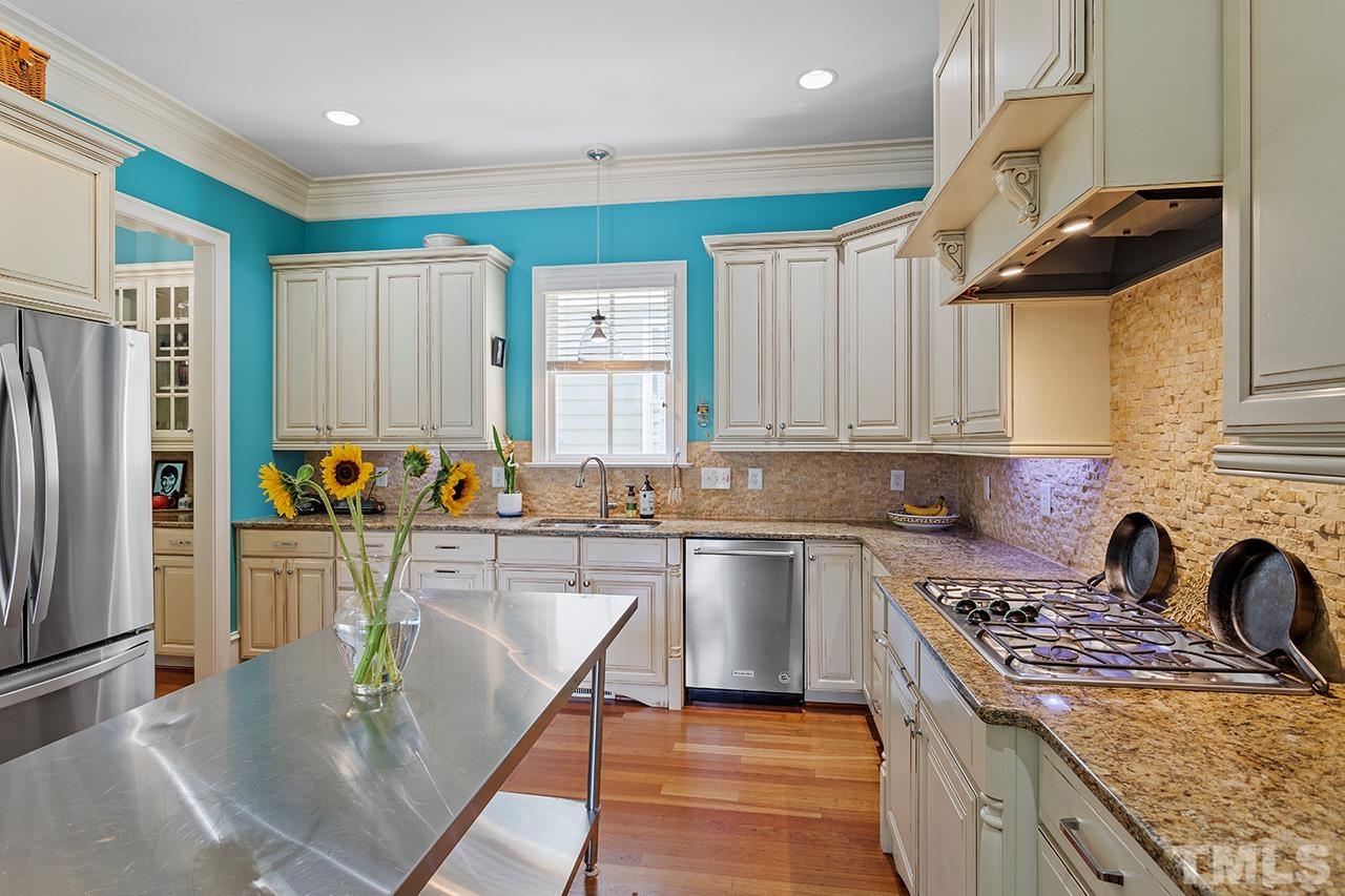 3100 Raymond Street Raleigh, NC 27607 - Photo 17 of 37 a kitchen with a stove a refrigerator and a sink
