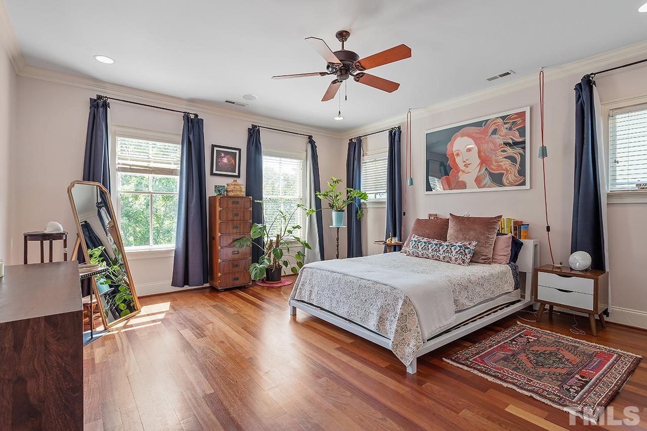 3100 Raymond Street Raleigh, NC 27607 - Photo 20 of 37 a bedroom with a large bed and a chandelier
