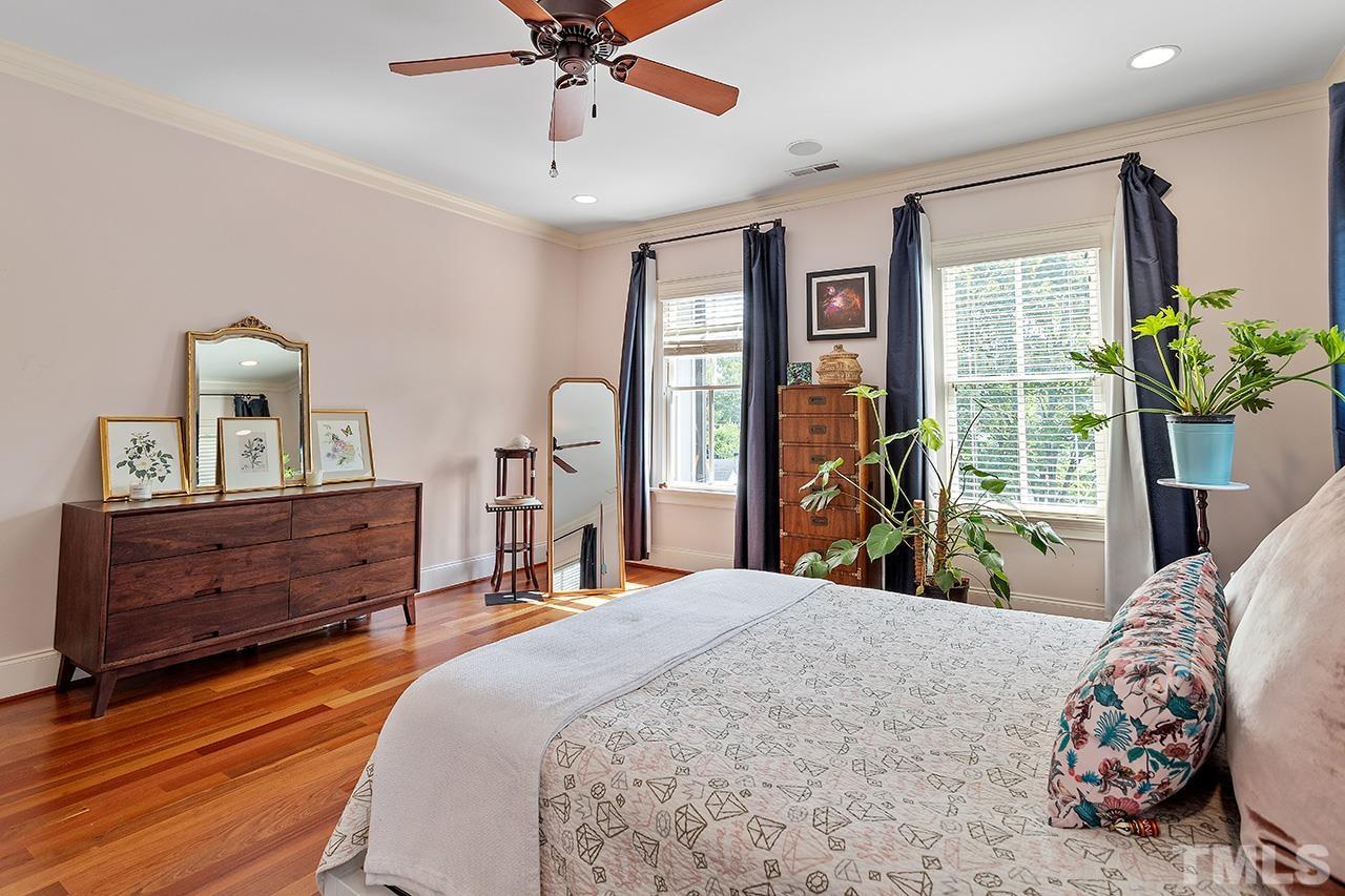 3100 Raymond Street Raleigh, NC 27607 - Photo 21 of 37 a bedroom with a bed and wooden floor