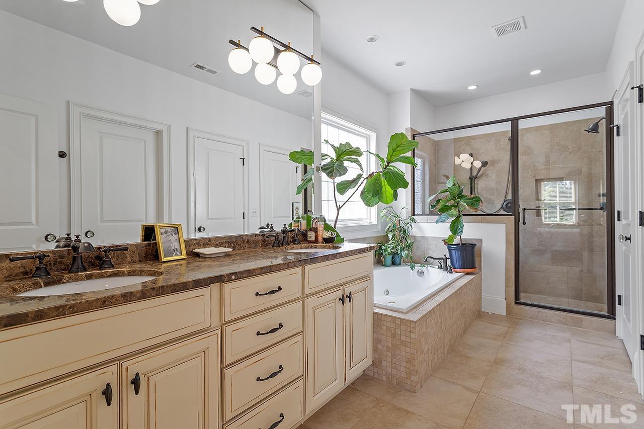 3100 Raymond Street Raleigh, NC 27607 - Photo 22 of 37 a spacious en suite bathroom with double sink and a mirror